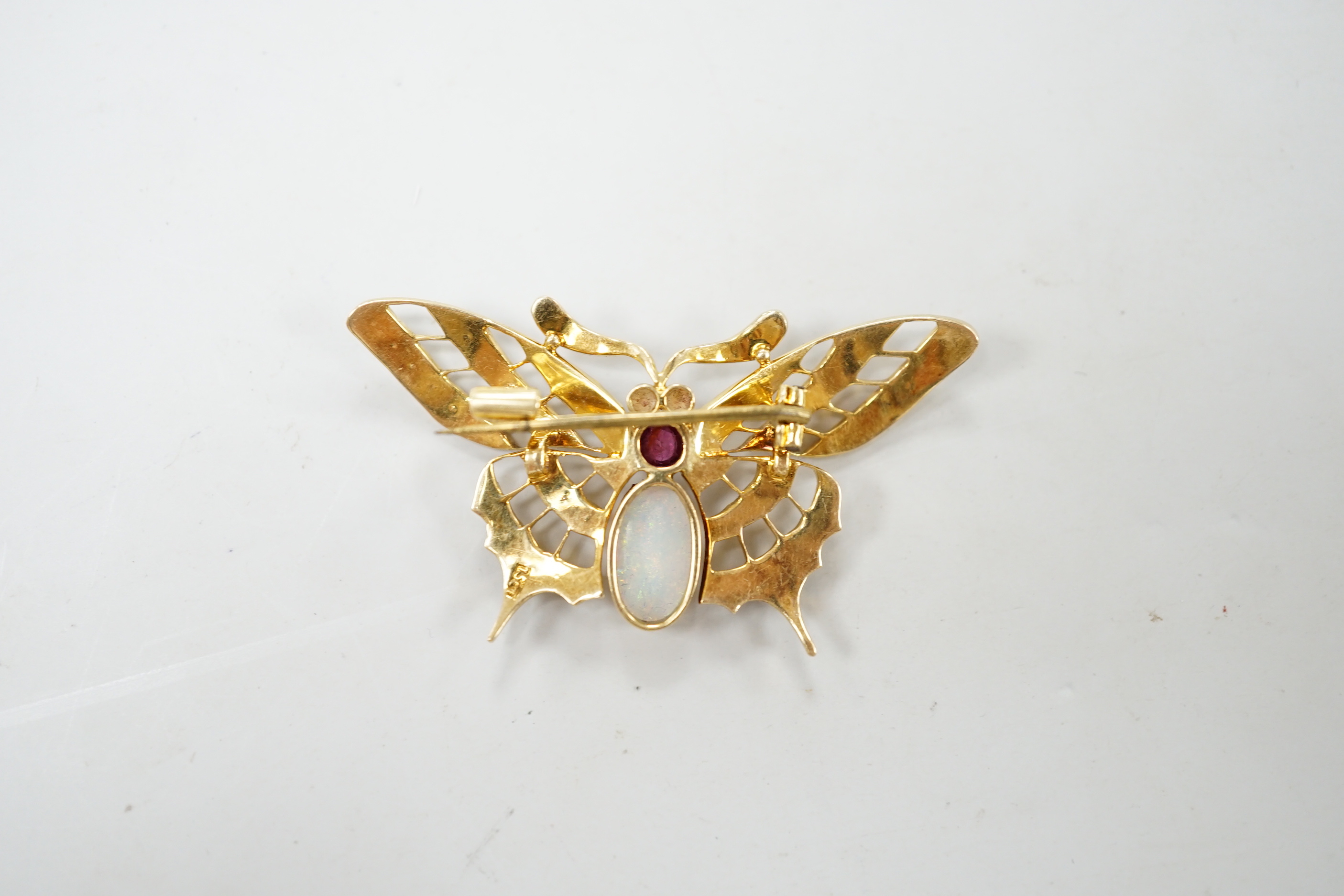 A yellow metal ruby, white opal and seed pearl cluster set bug brooch, width 48mm, gross weight 7 grams